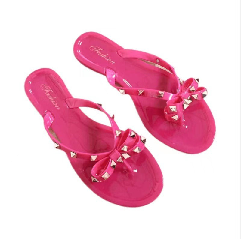 New style rivet shoes, bow shaped flip flops, summer beach outings, flat bottomed transparent jelly crystal slippers for women